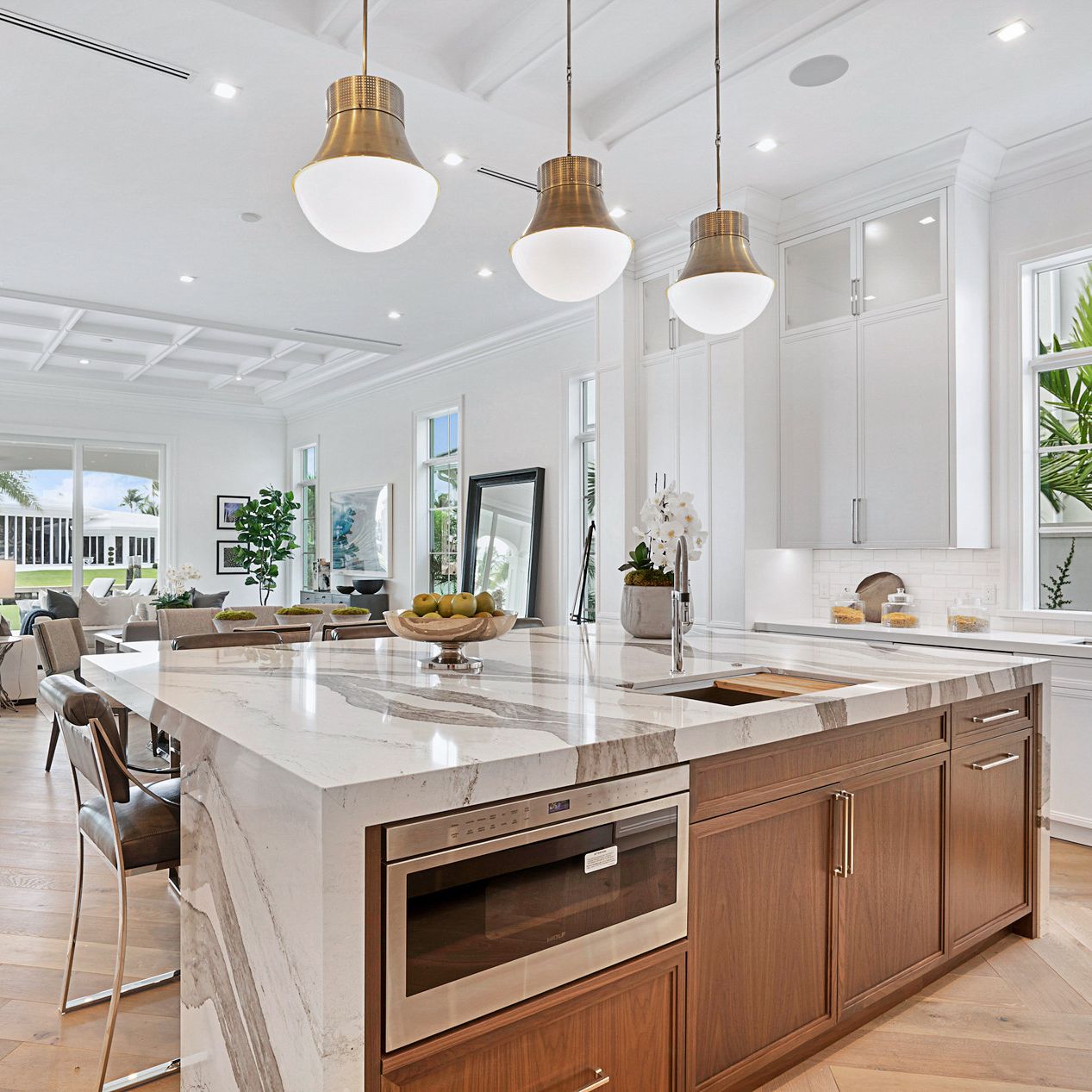 Cambria Skara Brae in a white kitchen with wood island cabinets.