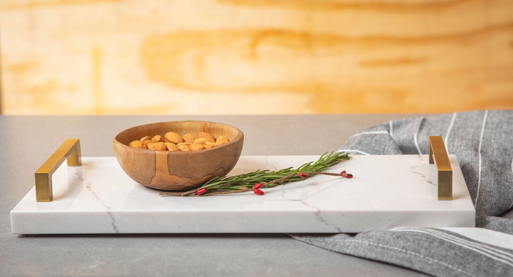 Cambria tray with handles with almonds in a wooden bowl on top.