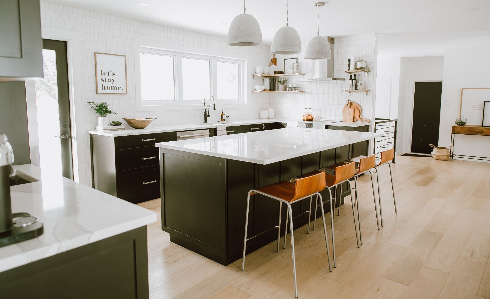 Light wood flooring and Brittanicca countertops create an open, airy feel.