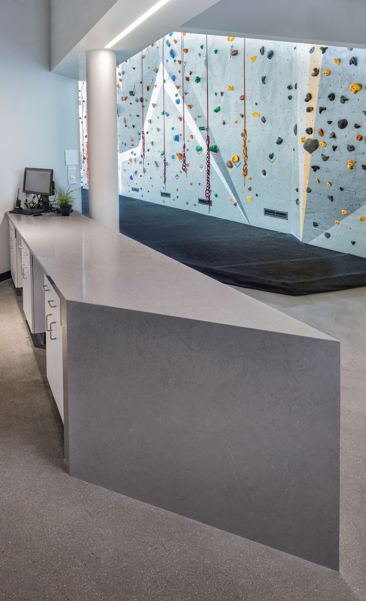 Concrete alternative reception desk in a wellness center featuring Cambria Carrick.