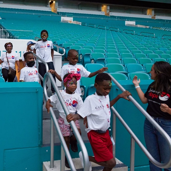 Miami Dolphins Partner with CITY Furniture and Surprise Over 100 South  Florida Kids with Beds at Annual Delivering Hope Event