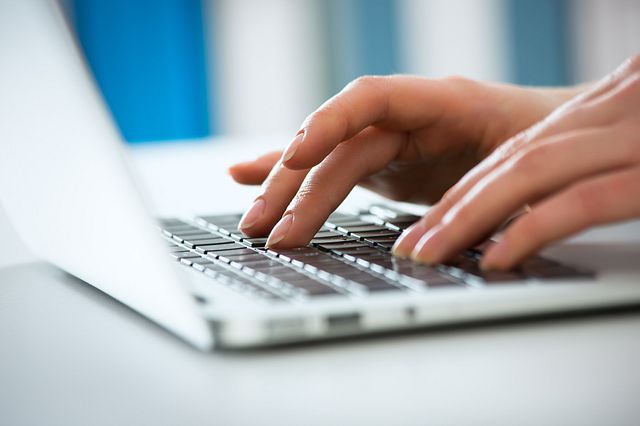 female hands on a PC laptop