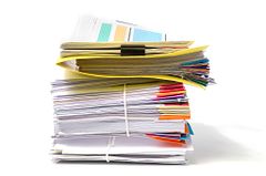 stack of white and colored documents isolated on a white background