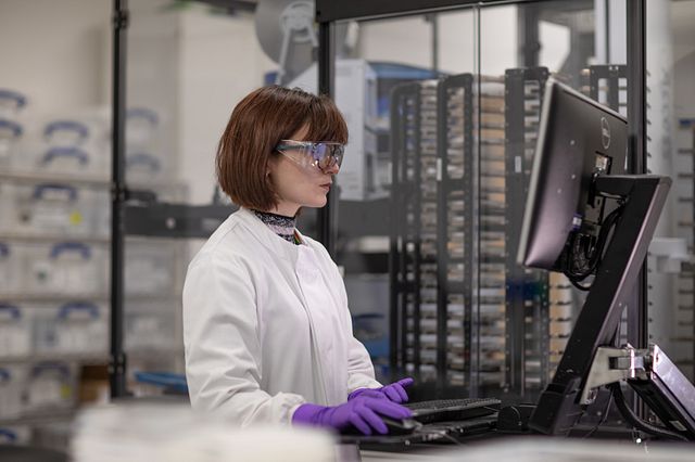 Image of women preparing microtiter plates for High-Throughput Screening. These plates contain cell-based assays for that will provide data to identify targets or leads and optimize compounds for use in drug discovery and development.