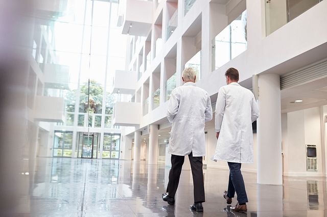Two scientists walking through the corridors of the laboratory consulting and collaborating to determine the best pathway forward for your drug development program
