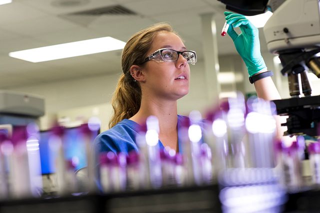scientist checking vial
