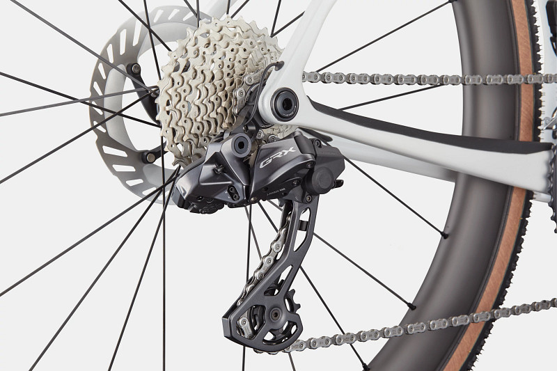 Close-up of a bicycle's rear derailleur and cassette, showcasing a sleek design and chain.