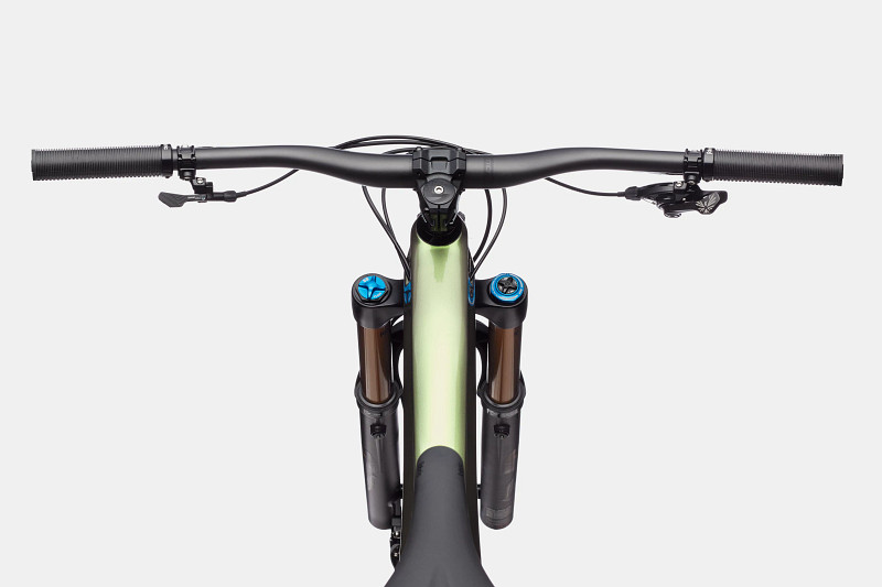 Top view of a mountain bike's handlebars, featuring grips, brake levers, and suspension forks with blue accents.