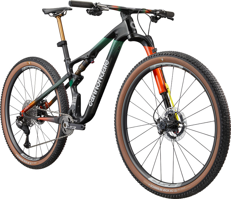 A modern mountain bike with a sleek black frame, colorful accents, and brown tires, showcasing advanced suspension and gear components.