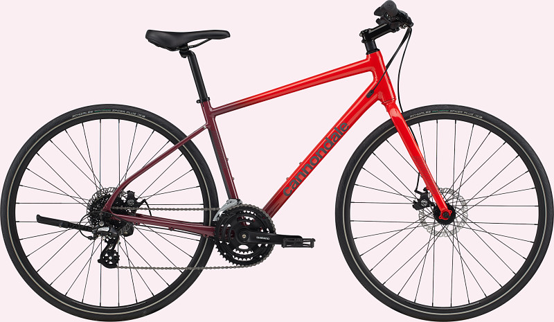 A red and maroon Cannondale bicycle with a sleek design, featuring a lightweight frame and modern components.