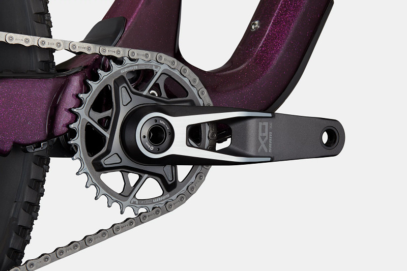 Close-up of a bicycle's crankset featuring a black and silver SRAM component, with a purple glittery frame and chain.