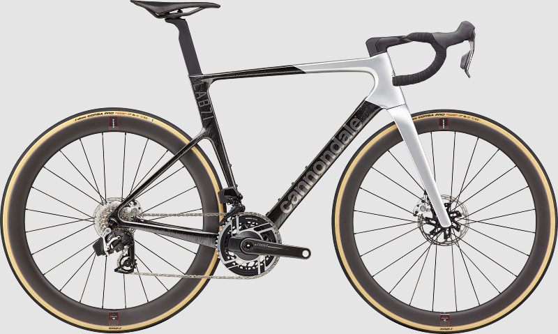 A sleek Cannondale bicycle featuring a black and white frame, aerodynamic design, and tan-treaded wheels.