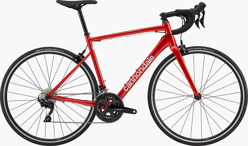 A sleek red Cannondale road bike with thin tires and a lightweight frame, designed for speed and performance.