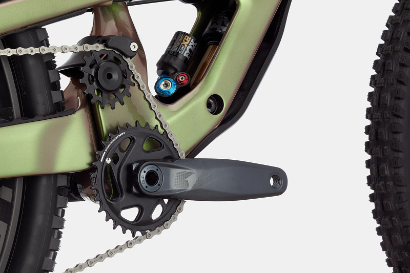 Close-up of a bicycle's drivetrain, featuring a green frame, chain, and crankset with a black chainring.