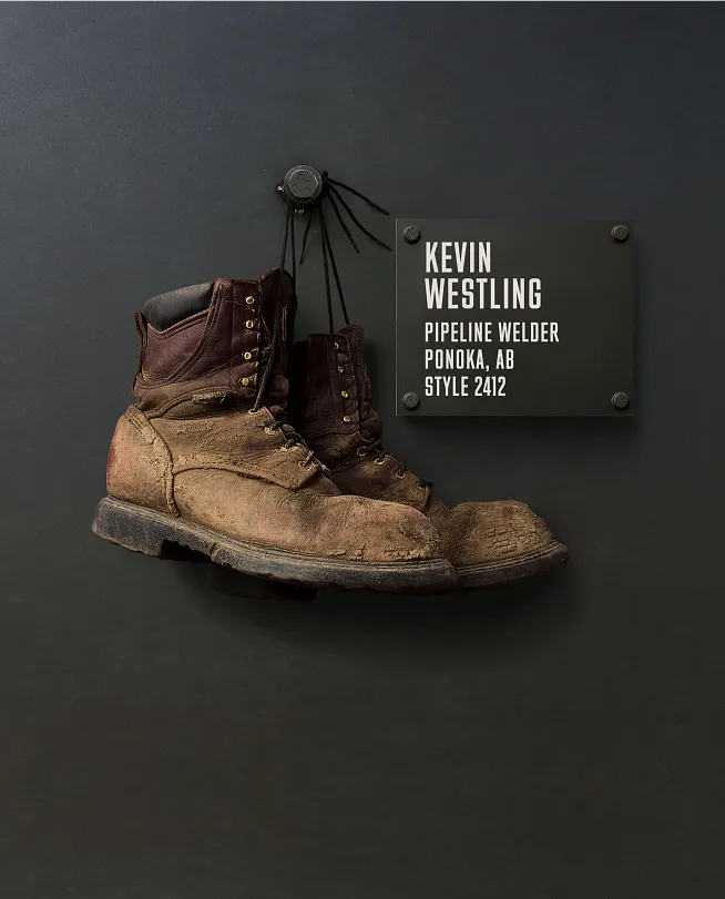 Kevin Westling's boots hanging on the Wall of Honor by a plaque with information