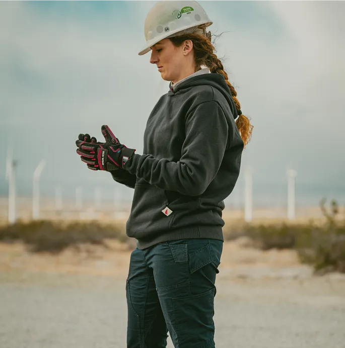 A woman in workwear standing in a field