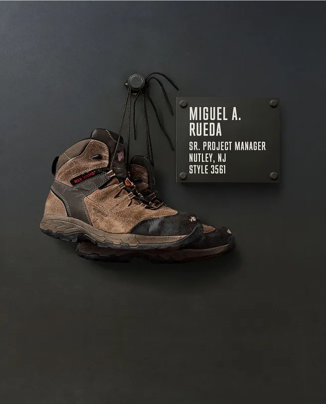 Miguel A. Rueda's boots hanging on the Wall of Honor by a plaque with information