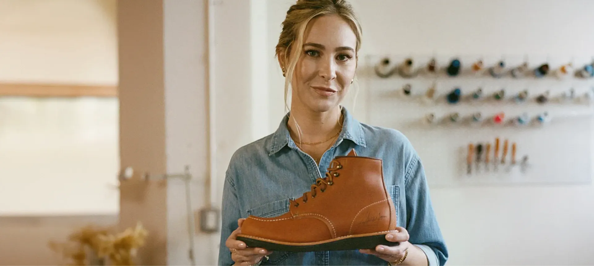Molly McQueen holding a Red Wing Boot