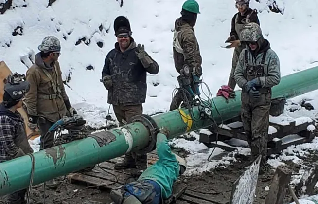 Kevin Westling and several other guys on a pipeline jobsite in the winter