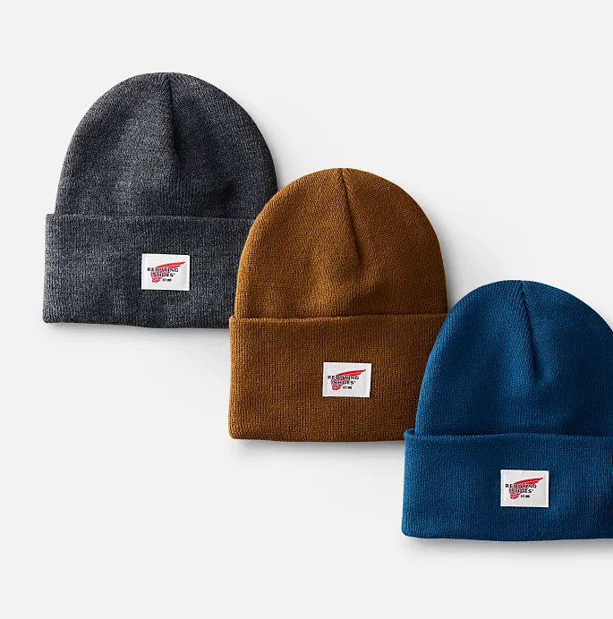 Three knit hats against a white background