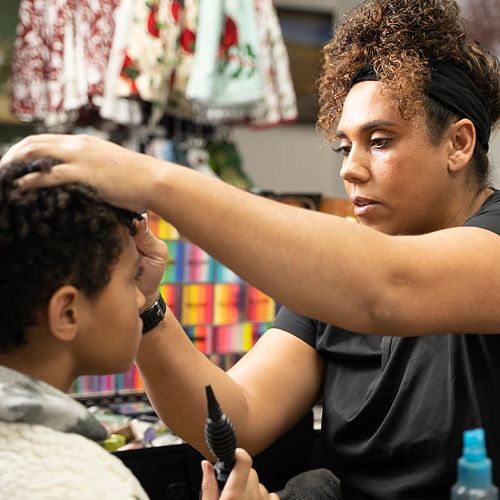 Andrea Race cutting someones hair