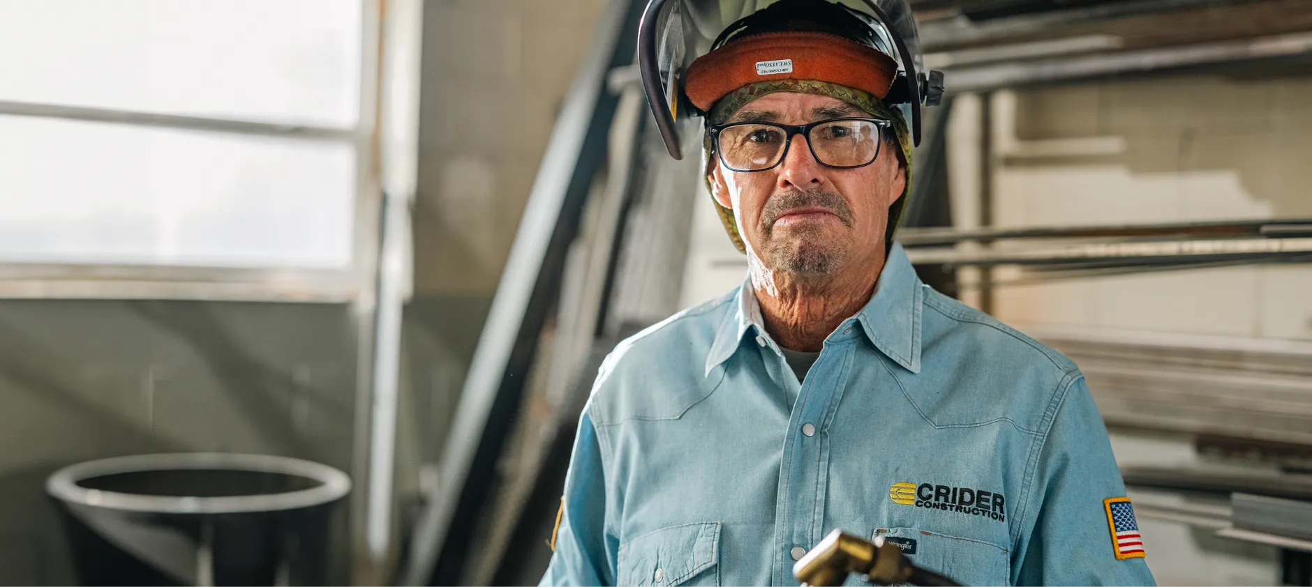 Closeup picture of Mike Crider wearing a welding helmet