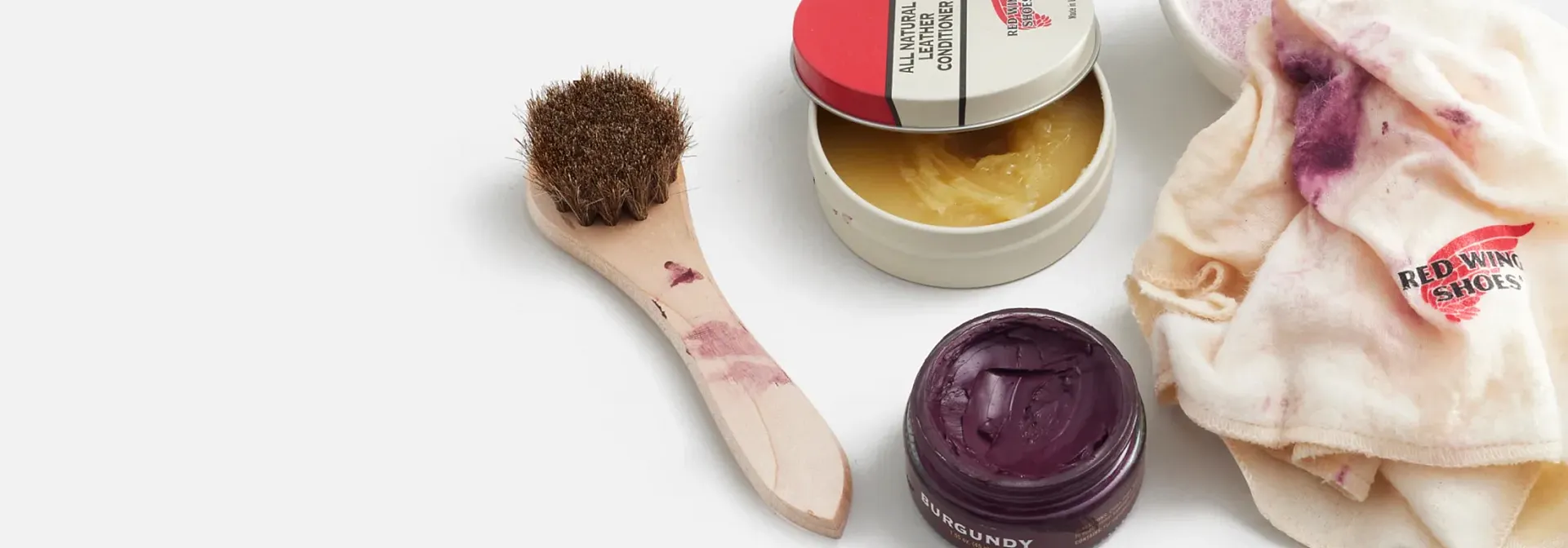 Picture of several different boot care items against a white background
