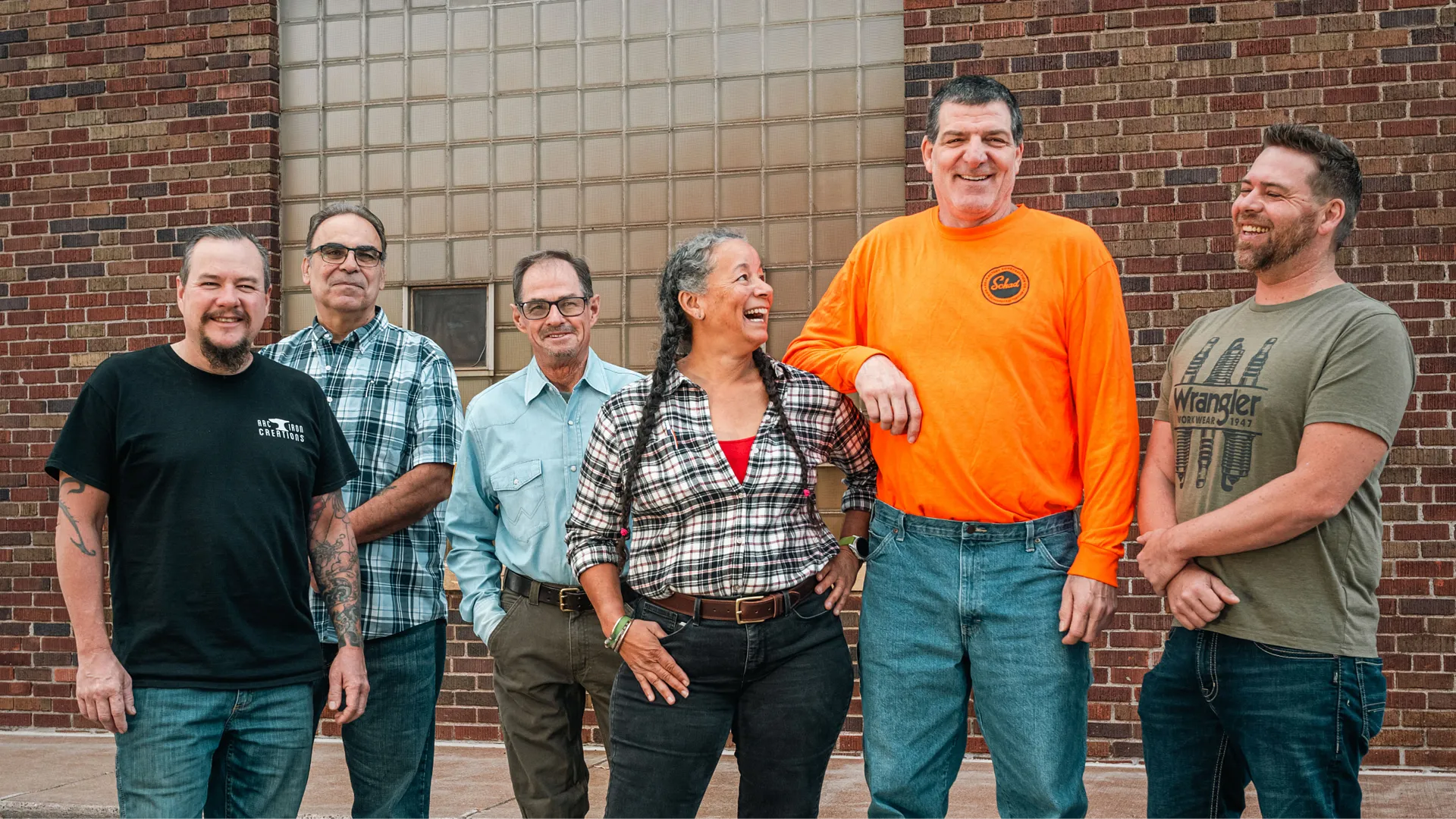 The six 2024 Wall of Honor Recipients standing by a brick wall