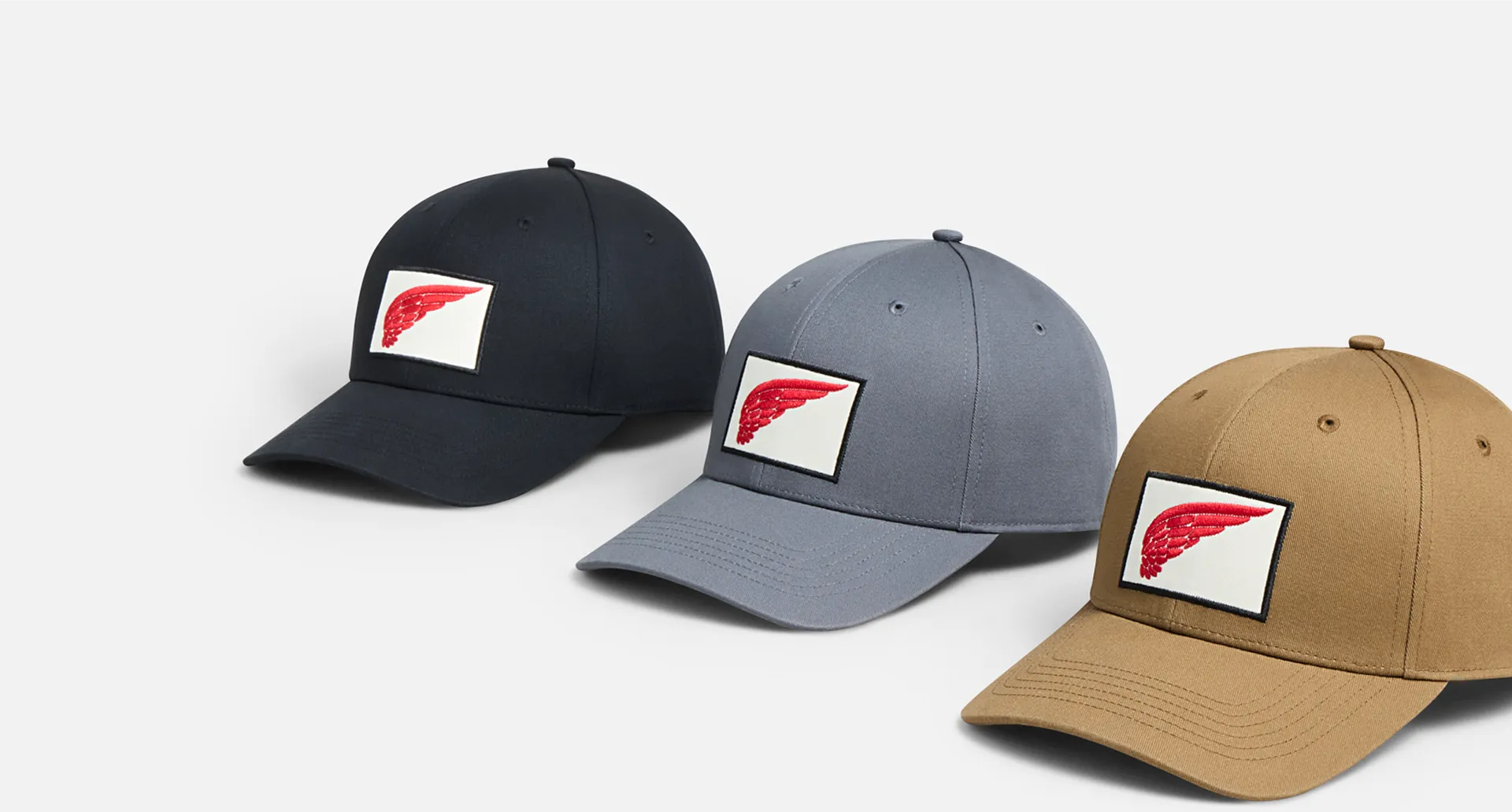3 baseball hats against a white background