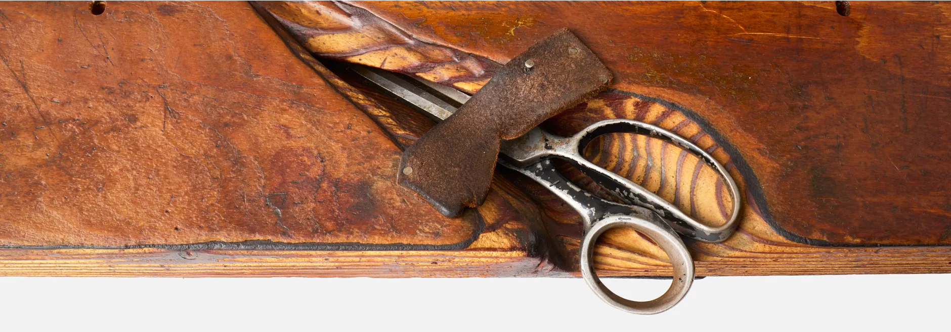 A pair of scissors on a work bench