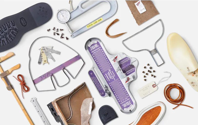A collection of boot making tools on a table