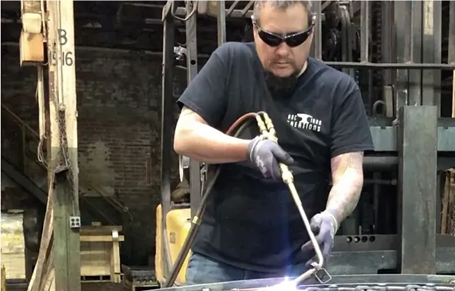 Andrew R. Chambers Jr. welding in a shop