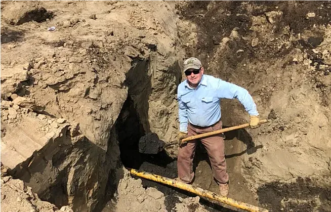 Mike Crider shoveling dirt at a pipeline jobsite
