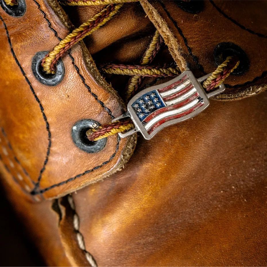 Close up of a Red Wing boot with an American flag lace charm on it