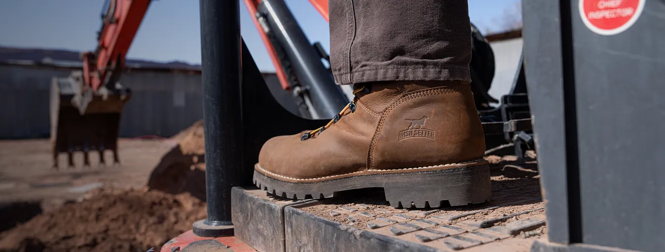 Close up of a Shorewood boot at a worksite with machinery in the background