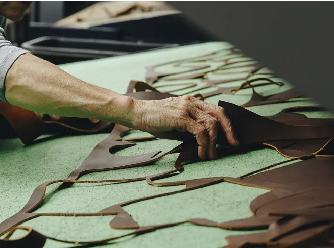 A hand holding leather cuttings