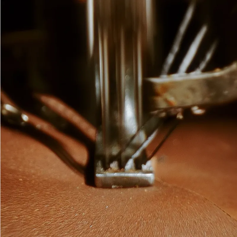 Close up of leather being sewn with sewing machine