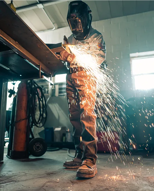 Mike Crider in a workshop welding