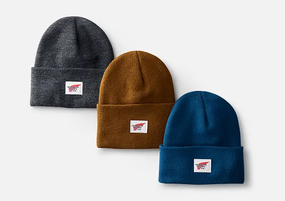 Overhead shot of 3 beanie hats against a white background