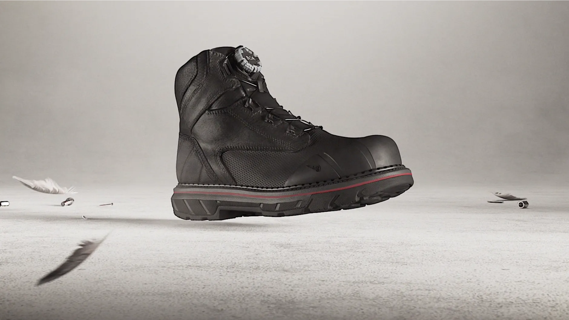 A single TruGuard Lite boot floating against a white background with a feather and nails