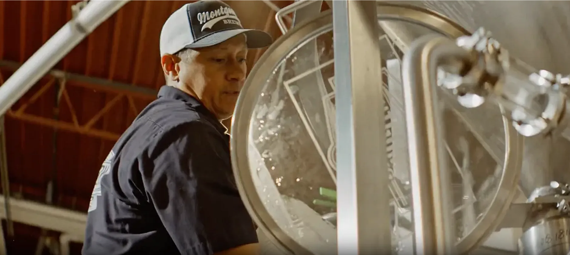 Picture of a man working at a brewery machine