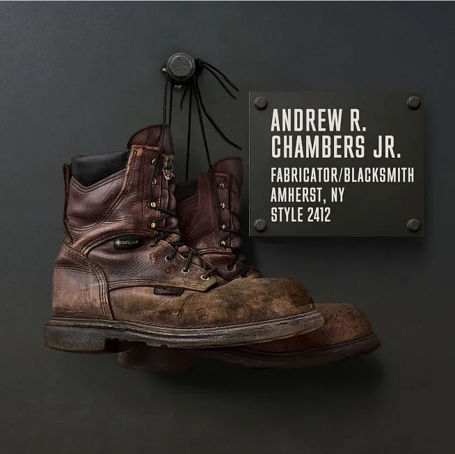 Andrew R. Chambers Jr.'s boots hanging on the Wall of Honor by a plaque with information