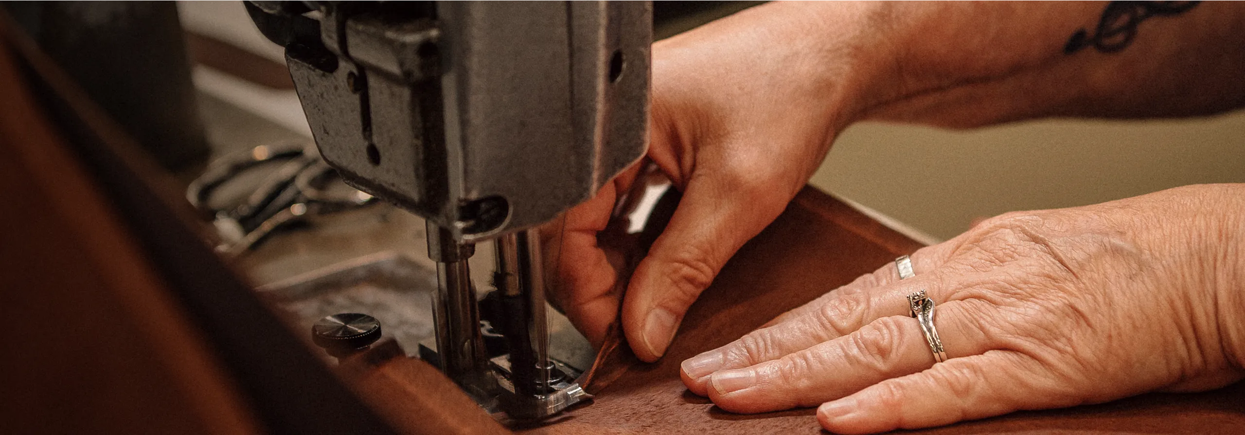 A woman in a factory working at a sewing machine