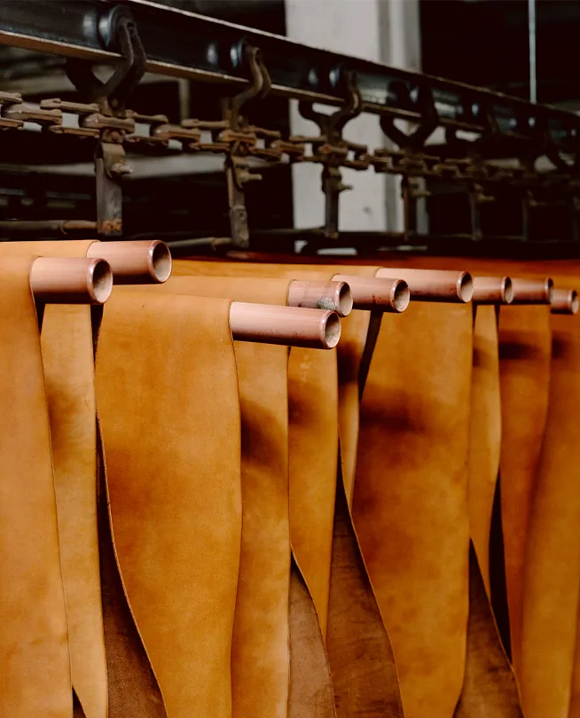 Leather hides hanging on a conveyor belt