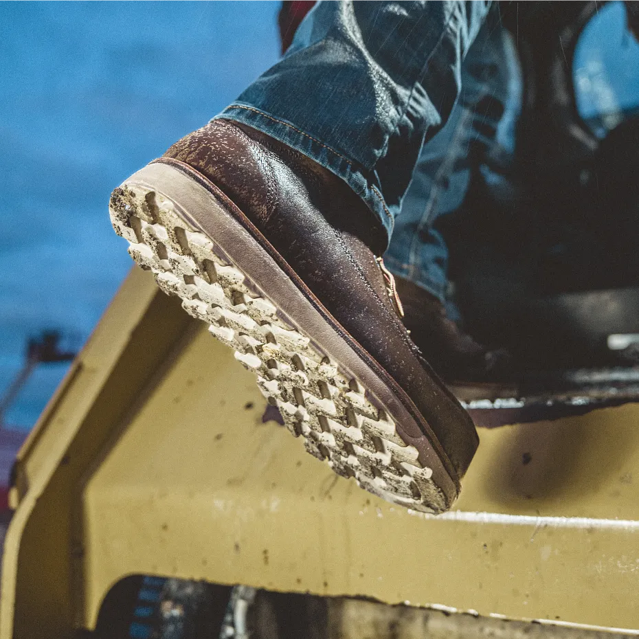 Closeup view of person's lower leg showing a boot sole