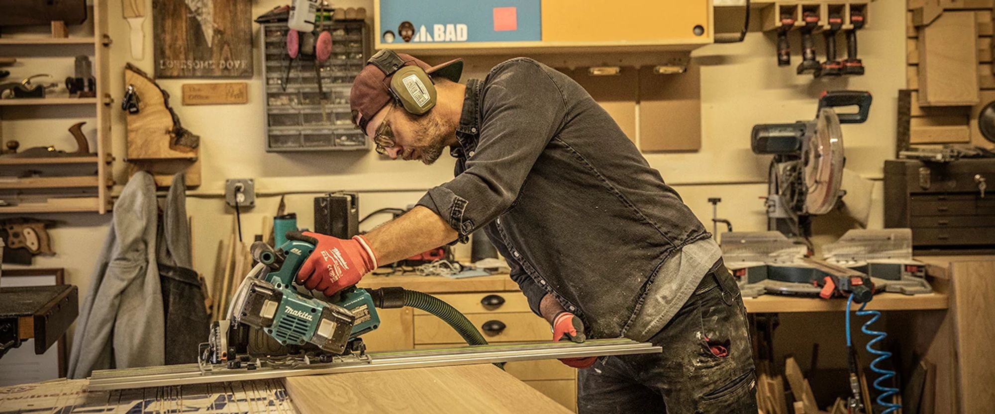 Taylor Hubbel cutting a wood board