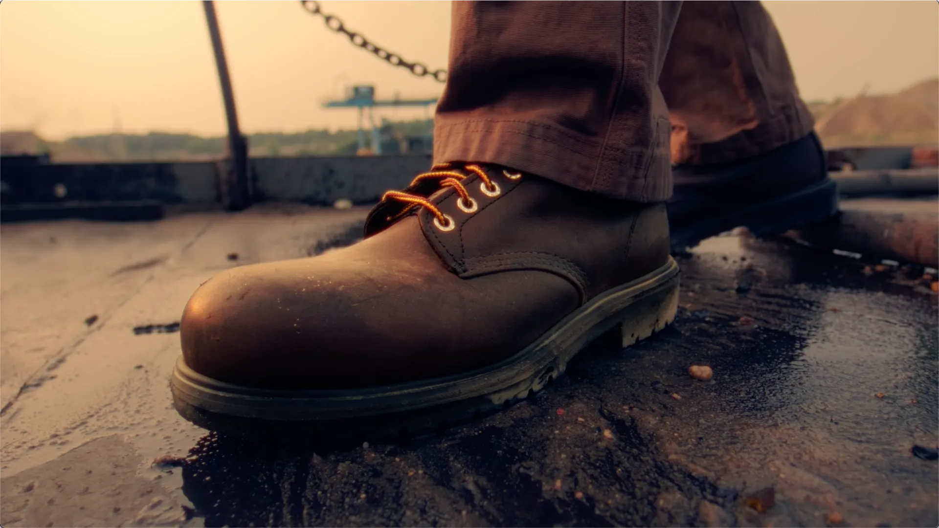 Close up of a boot stepping on a wet surface