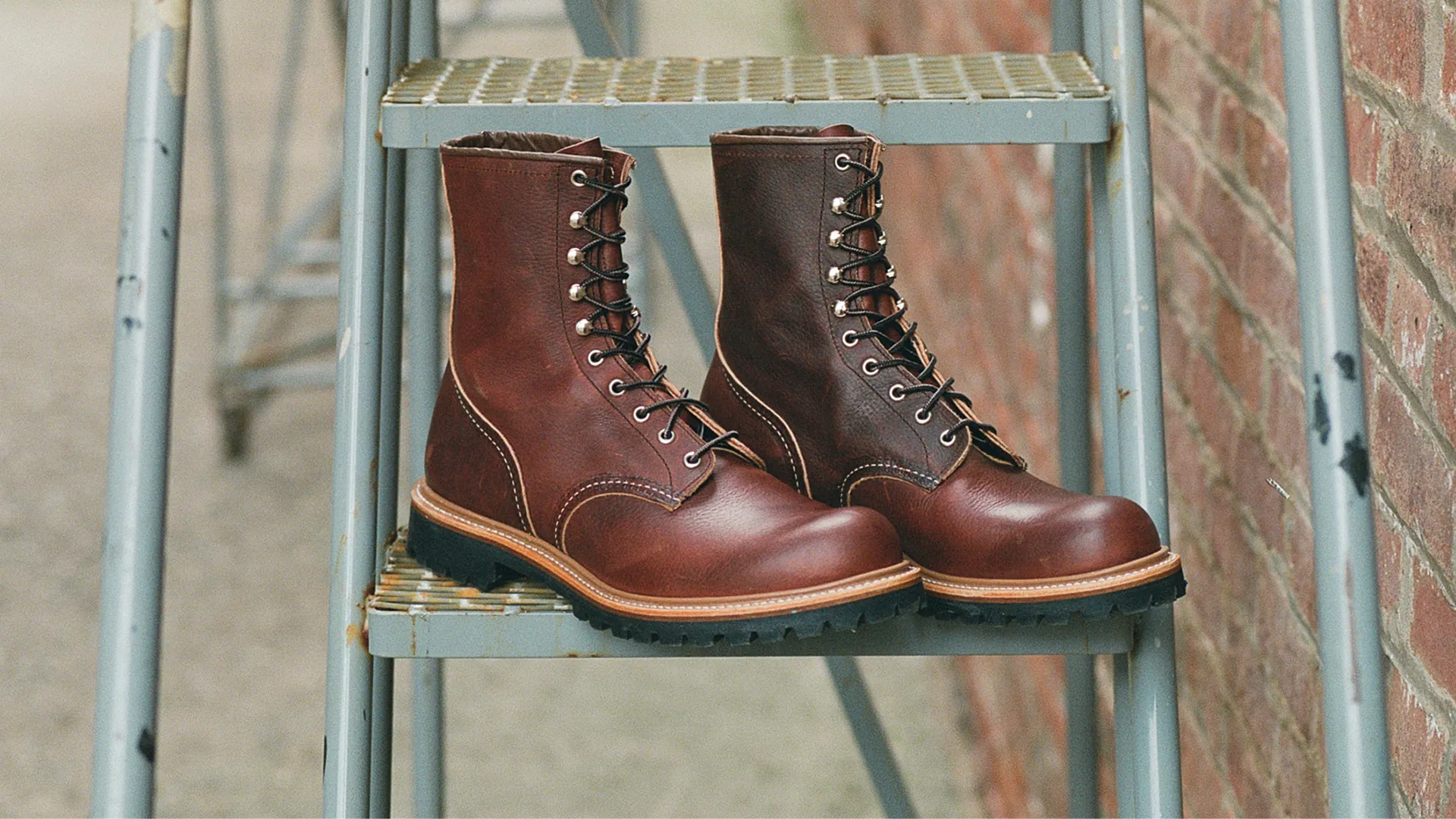 4 boots in a metal box against a white background