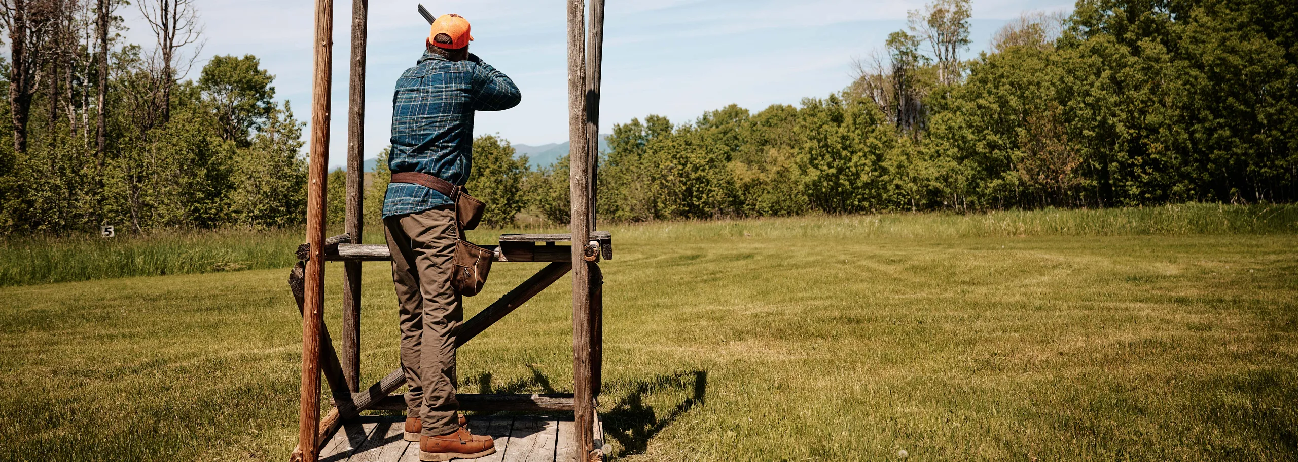 Man at an outdoor shooting station wearing Wingshooter boots