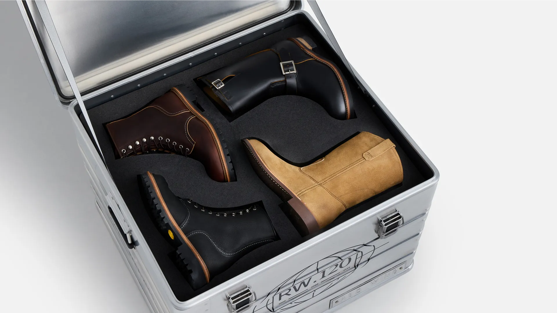 4 boots in a metal box against a white background